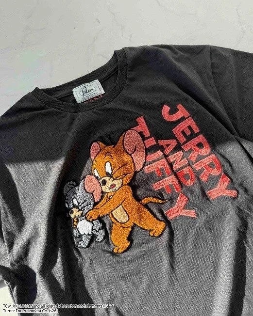 Close-up of Jerry and Tuffy fluffy embroidery on a black T-shirt