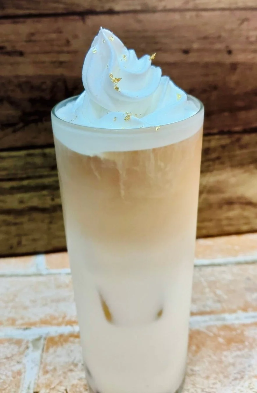 ホイップクリームと金箔が飾られた二層のアイスドリンク